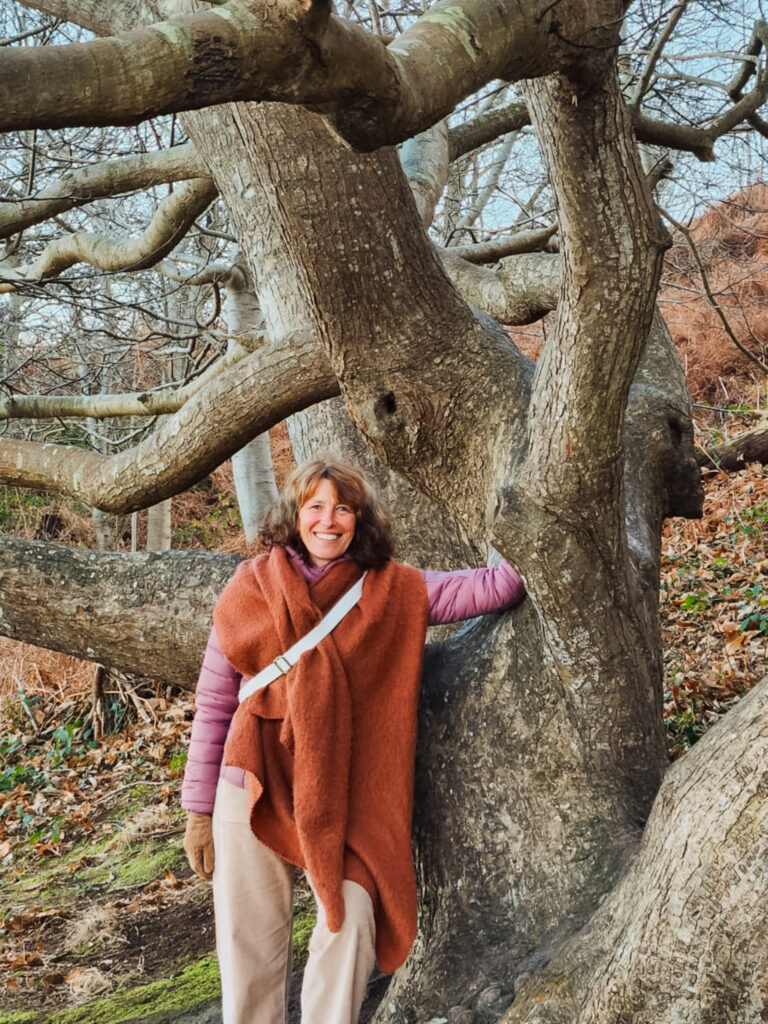 Portrait d'Hélène Conan debout contre un arbre